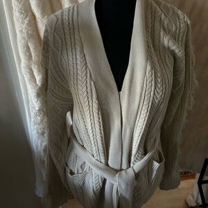 A little frilly up the sleeves creamy sweater size M